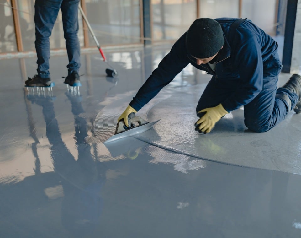 worker applies gray epoxy resin