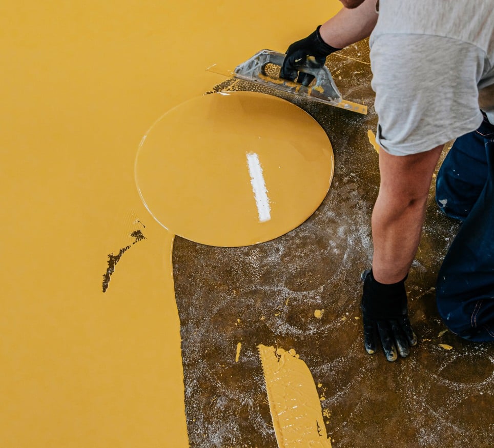 worker coating floor self leveling epoxy resin industrial workshop